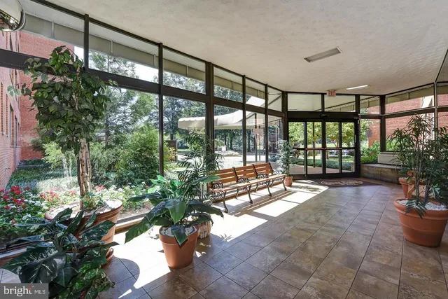 a lobby with a floor to ceiling window and wooden floor