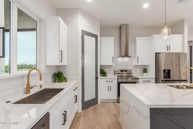 a kitchen with white cabinets and appliances