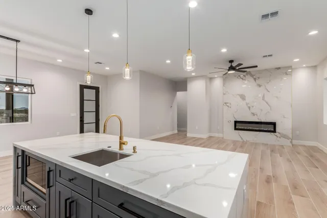 a kitchen with kitchen island a sink stainless steel appliances and cabinets