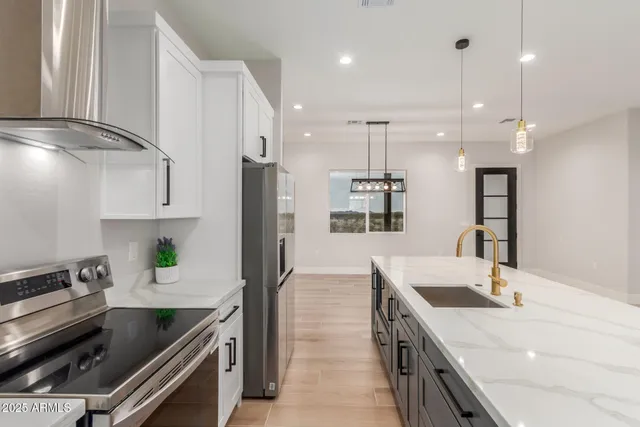 a kitchen with a sink a counter top space stainless steel appliances and a window