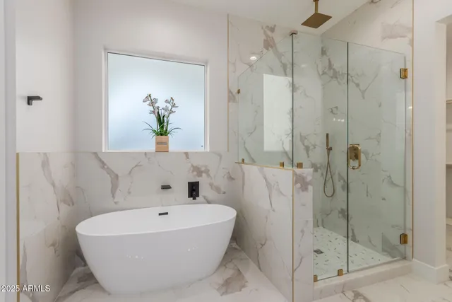 a bathroom with a bathtub and shower
