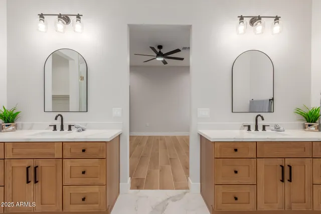 a bathroom with a double vanity sink and mirror