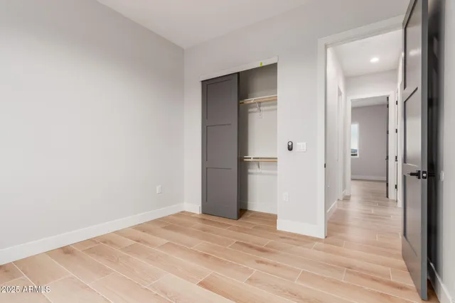 a view of a room with wooden floor and bathroom