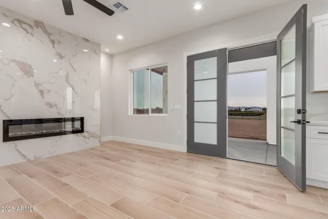 an empty room with windows and closet