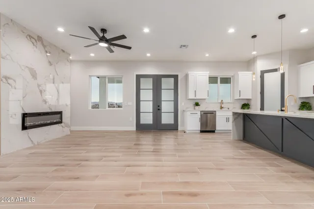 a large white kitchen with lots of counter space and window