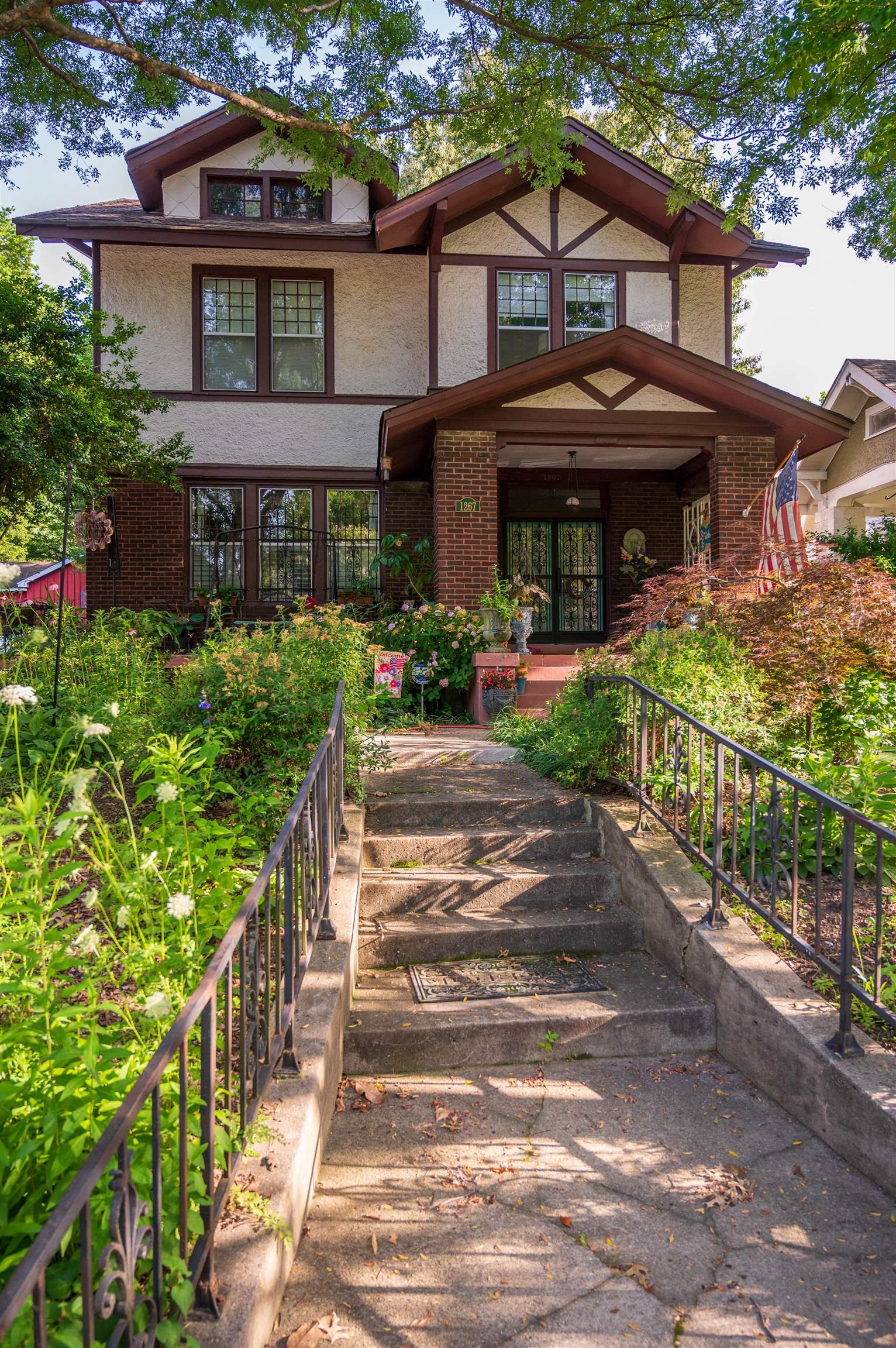 1267 Central Avenue Memphis, TN 38104 - Photo 2 of 25 a front view of a house with a yard and potted plants