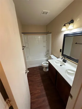a bathroom with a sink a mirror and a toilet