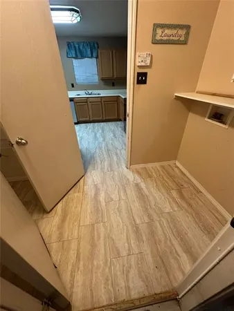 a view of kitchen with cabinets and wooden floor