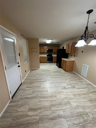 a view of a kitchen with a sink and cabinets