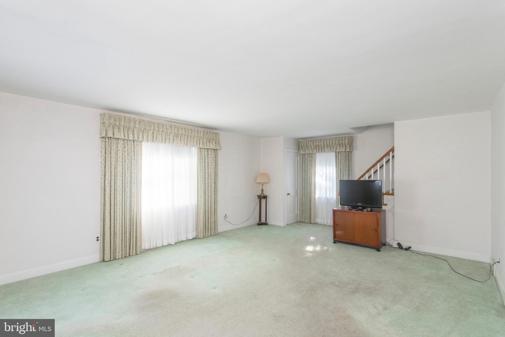 16 West Avenue Springfield, PA 19064 - Photo 13 of 34 an empty room with stairs and a window
