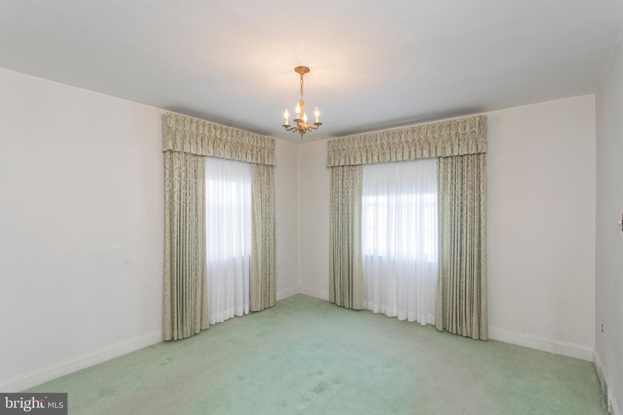 16 West Avenue Springfield, PA 19064 - Photo 15 of 34 an empty room that has a chandelier fan and windows