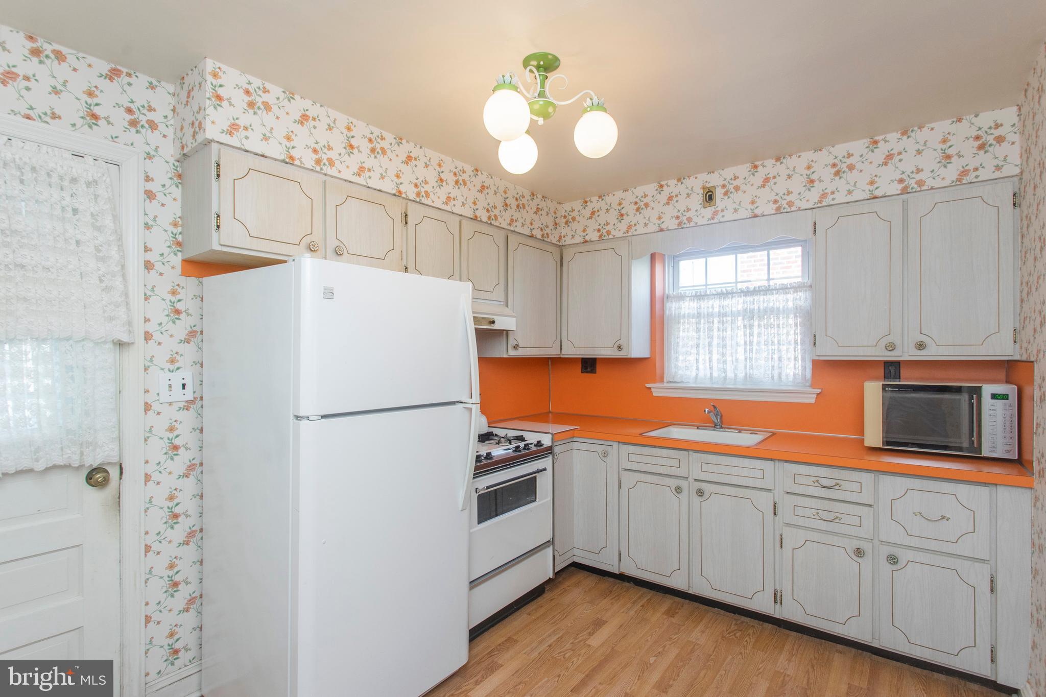 16 West Avenue Springfield, PA 19064 - Photo 17 of 34 a white refrigerator freezer sitting inside of a kitchen
