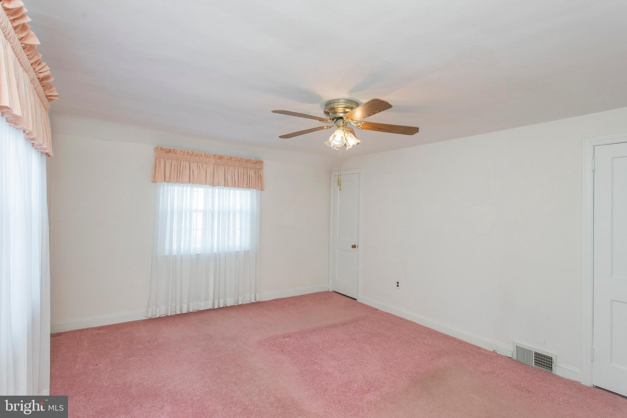 16 West Avenue Springfield, PA 19064 - Photo 23 of 34 an empty room with windows and chandelier fan