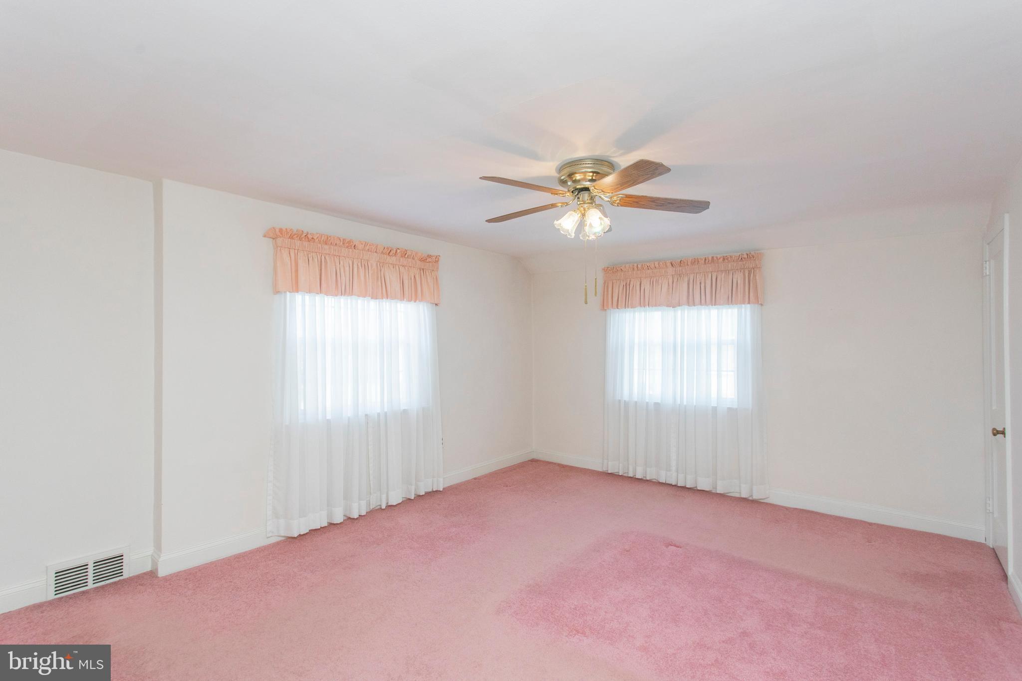 16 West Avenue Springfield, PA 19064 - Photo 24 of 34 an empty room with windows and chandelier fan