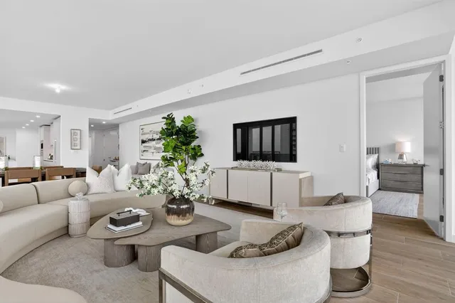 a living room with furniture and floor to ceiling windows