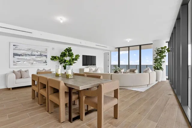 a living room with furniture and a floor to ceiling window