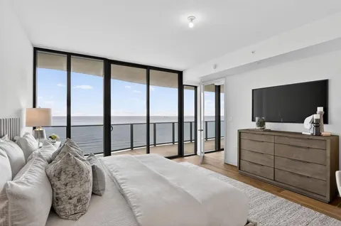 a bathroom with a shower sink vanity mirror and toilet