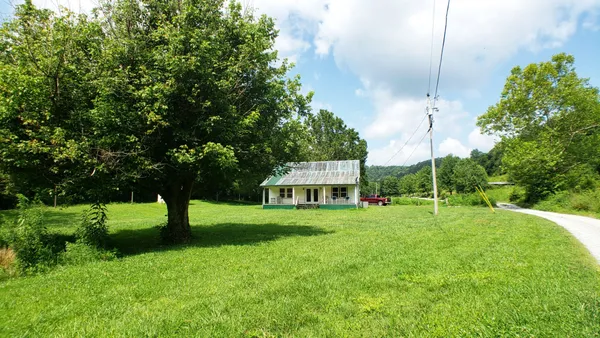 a view of an house with backyard space and garden