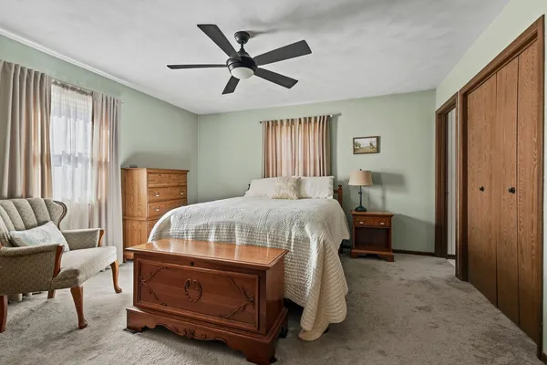a bedroom with a bed and a couch