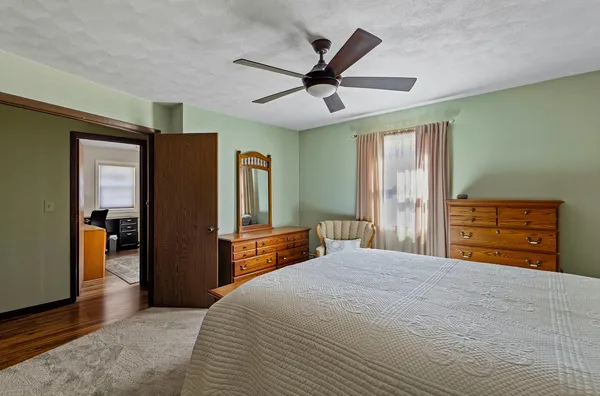 a bedroom with a bed and a chandelier