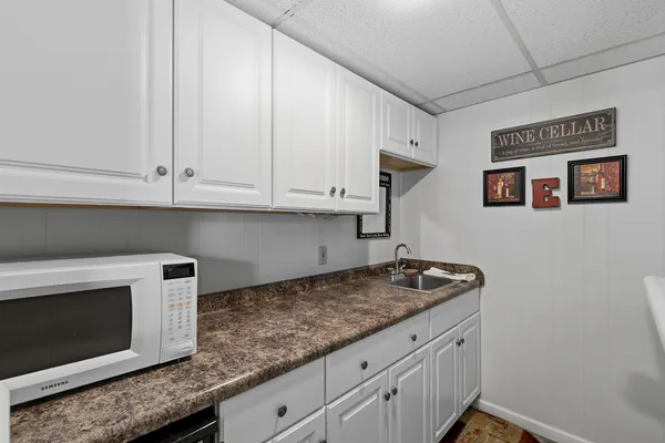 a kitchen with granite countertop white cabinets and a stainless steel appliances