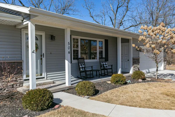 a view of a house with a large tree