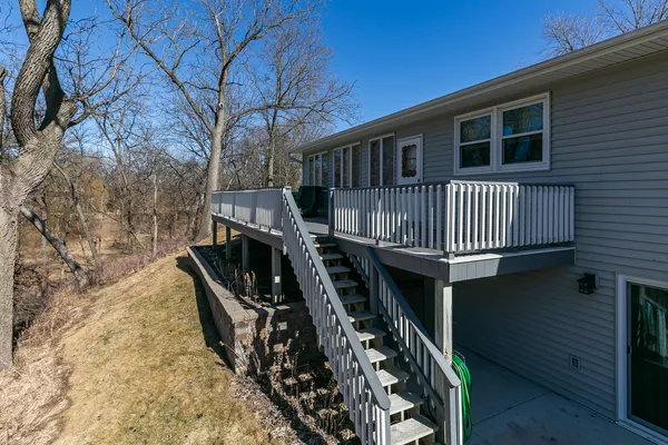 a view of wooden house with a deck