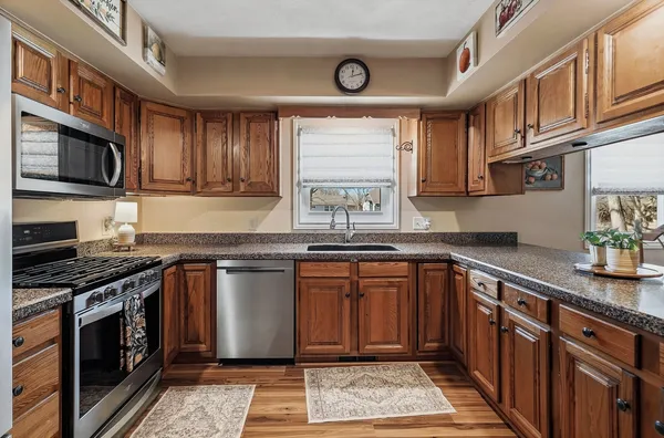 a kitchen with stainless steel appliances granite countertop a stove and a sink