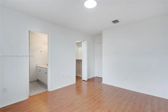 a bathroom with a tub sink mirror and a shower
