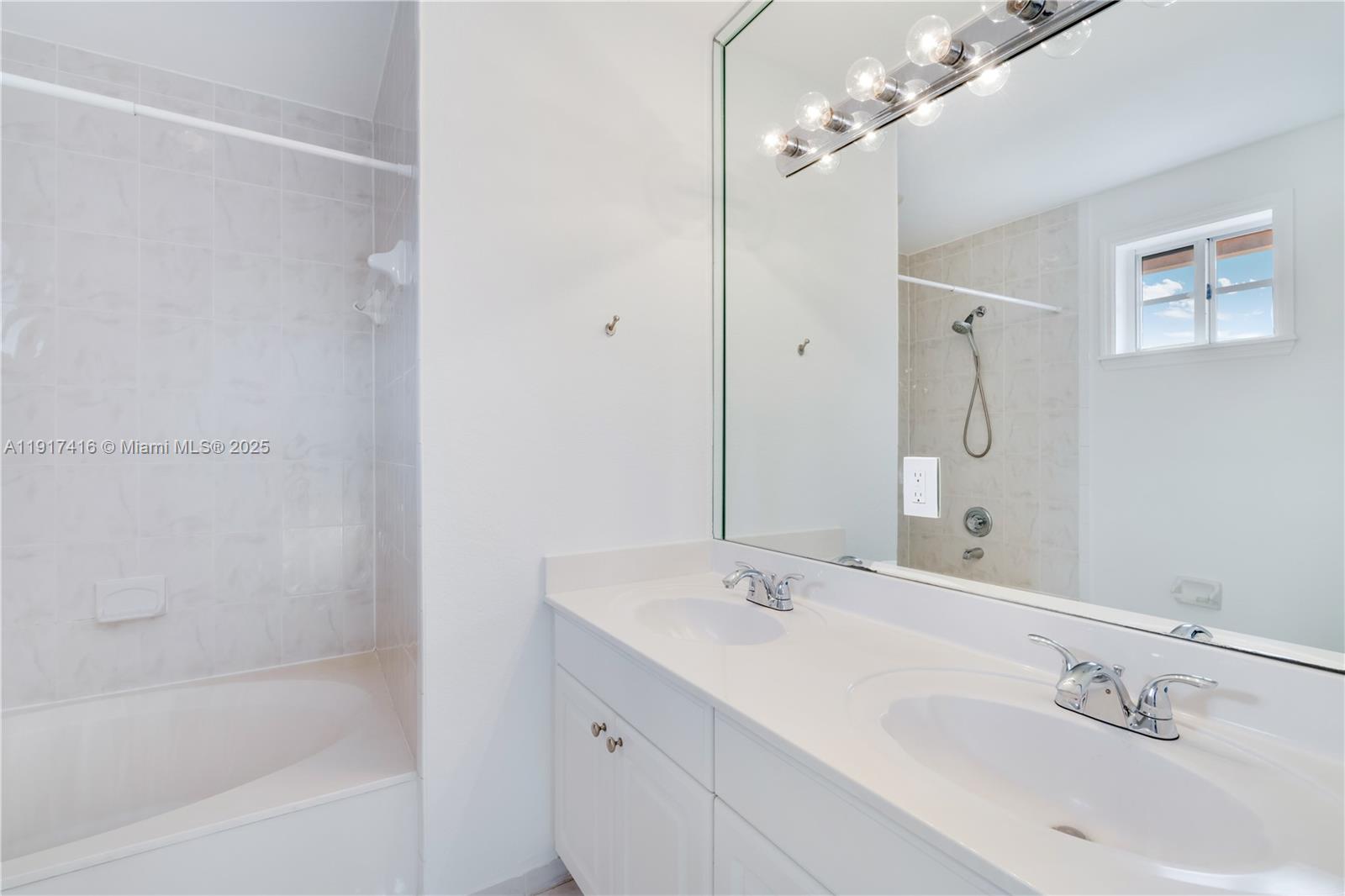 9481 Southwest 78th Avenue Miami, FL 33156 - Photo 24 of 45 a bathroom with a tub sink mirror and a shower