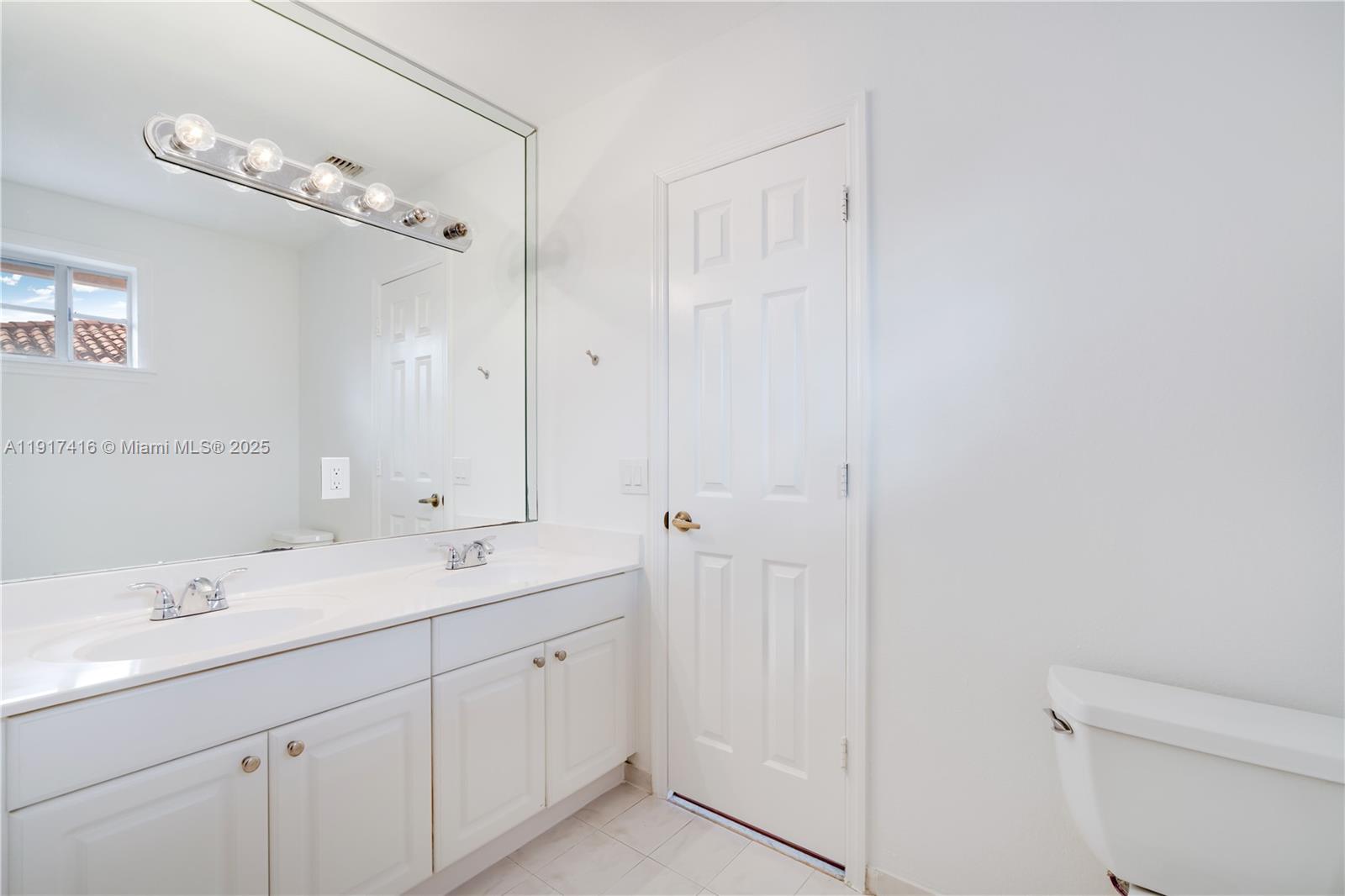 9481 Southwest 78th Avenue Miami, FL 33156 - Photo 26 of 45 a spacious bathroom with a double vanity sink mirror and toilet