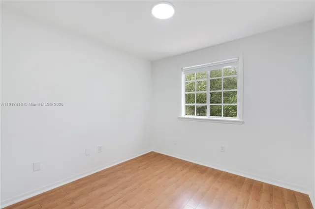 a view of hallway with wooden floor