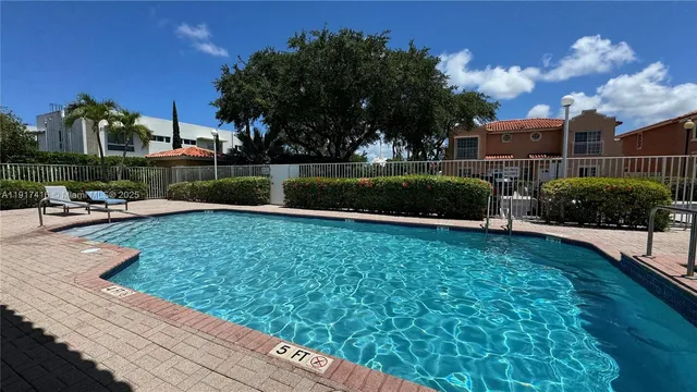 a swimming pool with outdoor seating and yard