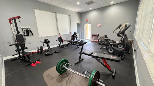 a room with gym equipment and a large window