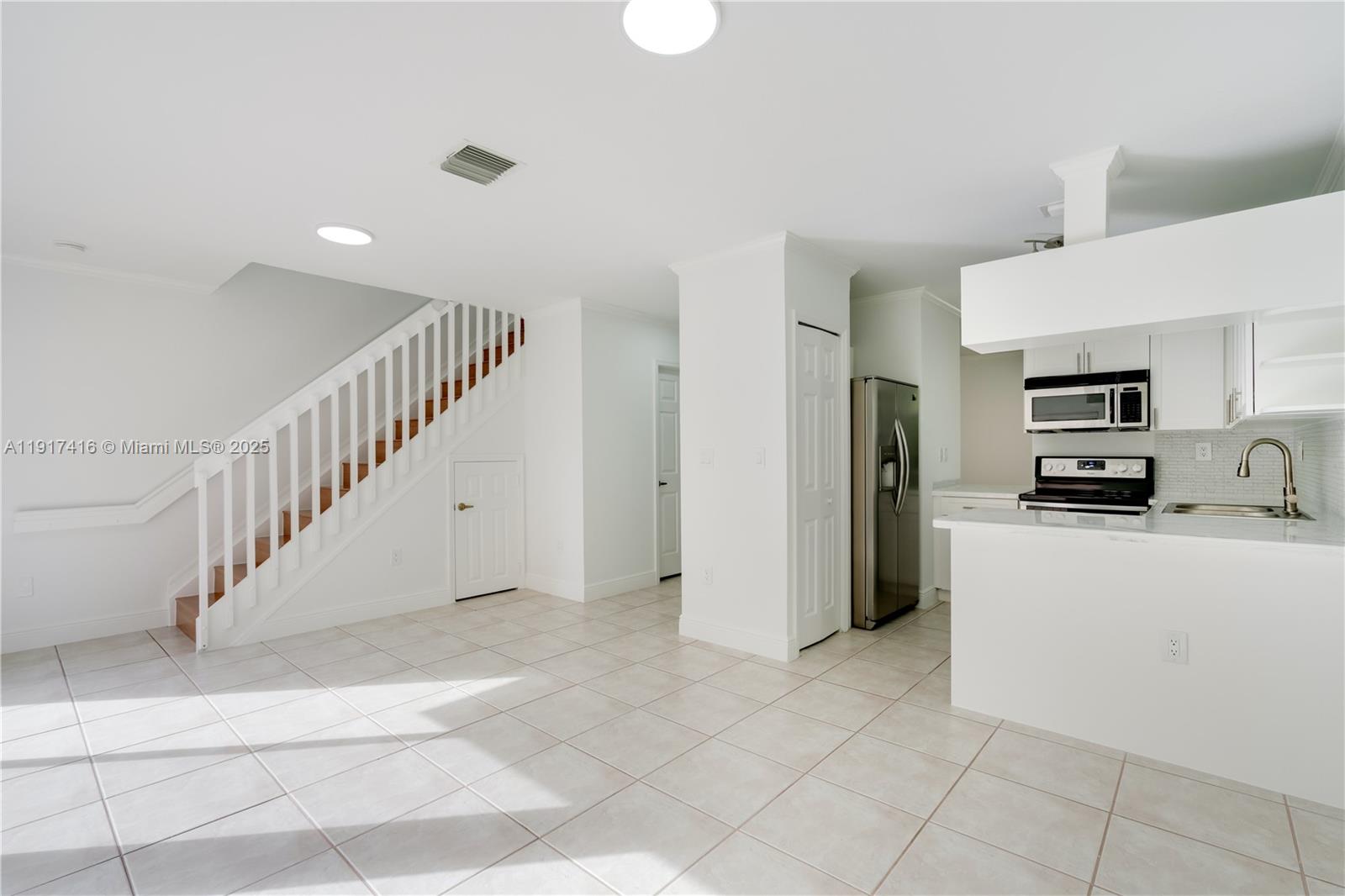 9481 Southwest 78th Avenue Miami, FL 33156 - Photo 5 of 45 a view of kitchen with stainless steel appliances refrigerator stove microwave and cabinets