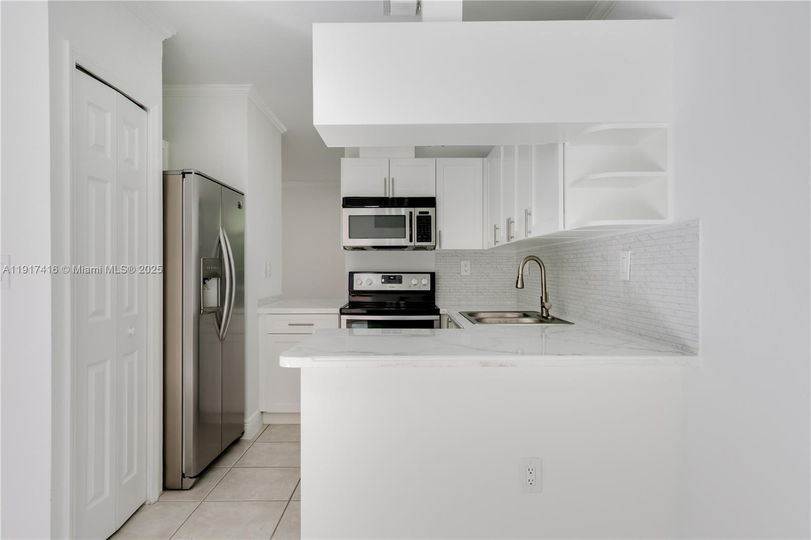 9481 Southwest 78th Avenue Miami, FL 33156 - Photo 7 of 45 a kitchen with a refrigerator a stove top oven and a refrigerator