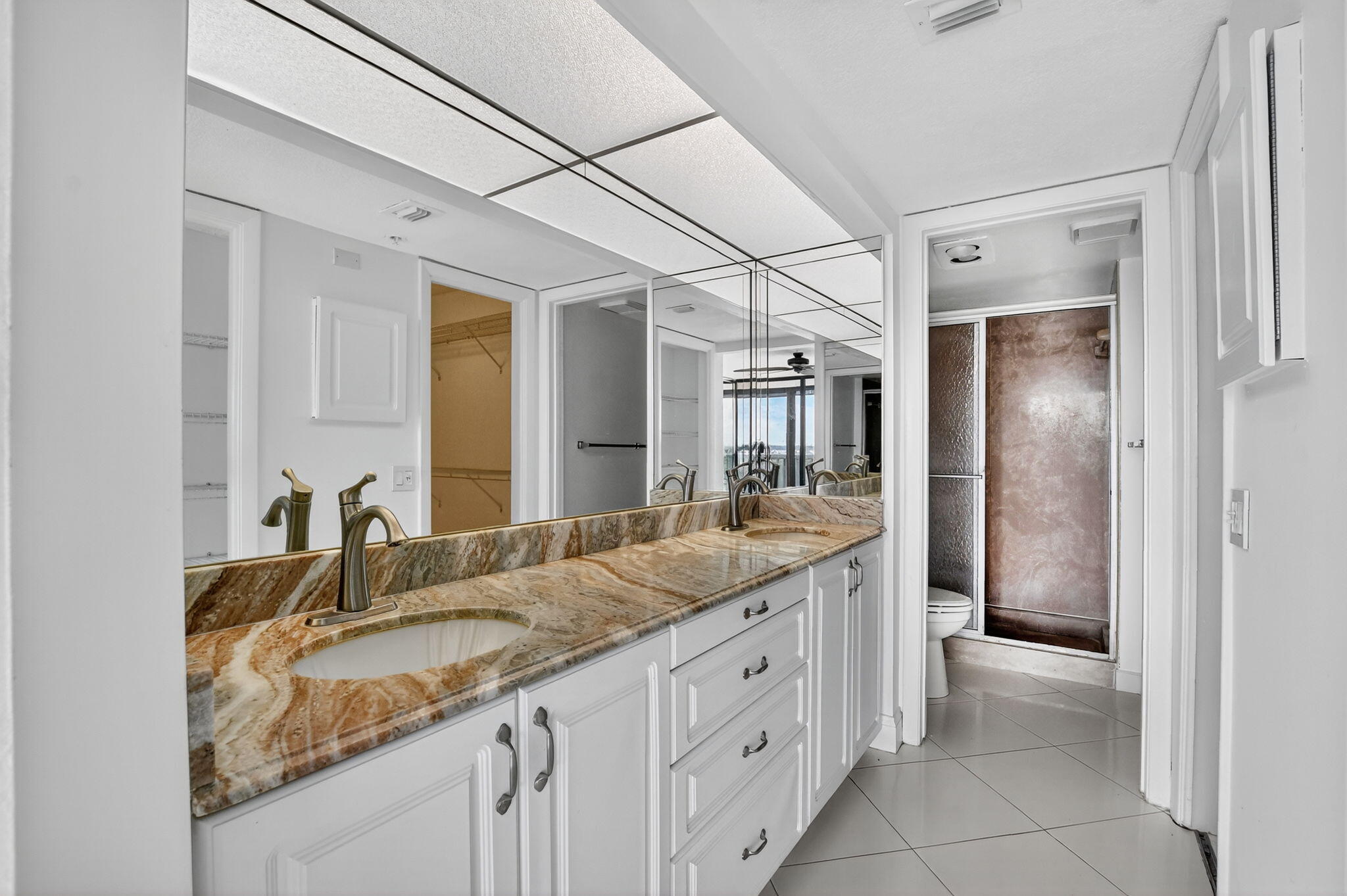 6620 Boca Del Mar Drive, Unit 706 Boca Raton, FL 33433 - Photo 14 of 41 a bathroom with a granite countertop double vanity sink and mirror