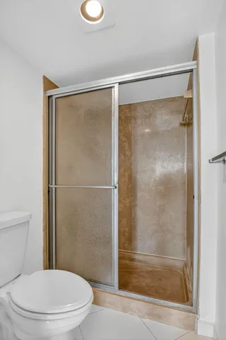 a bathroom with a glass shower door
