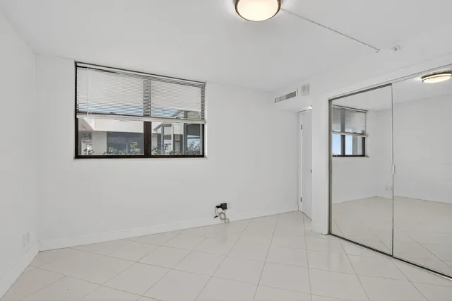 a view of a room with a large mirror and shower
