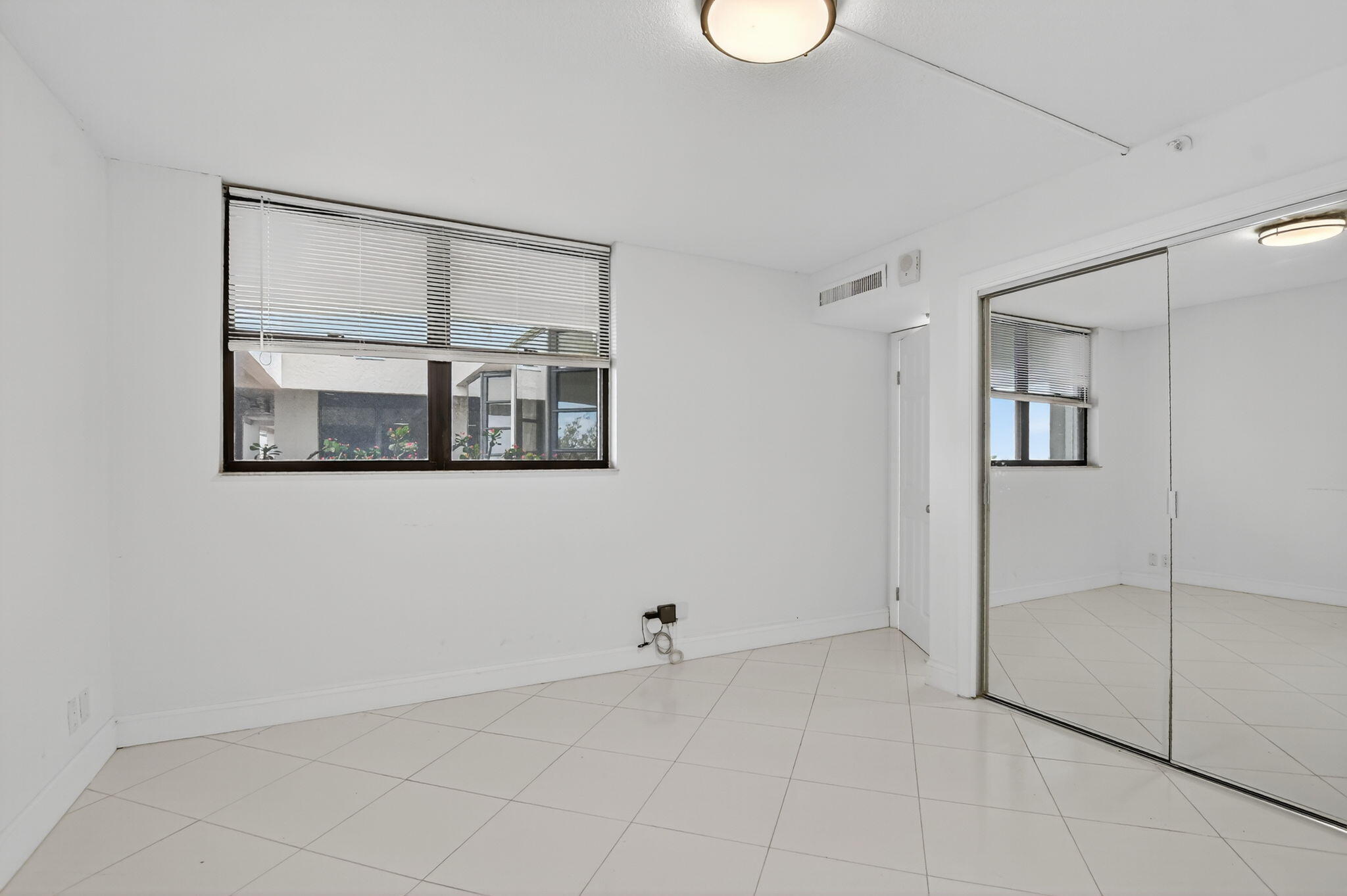 6620 Boca Del Mar Drive, Unit 706 Boca Raton, FL 33433 - Photo 17 of 41 a view of a room with a large mirror and shower
