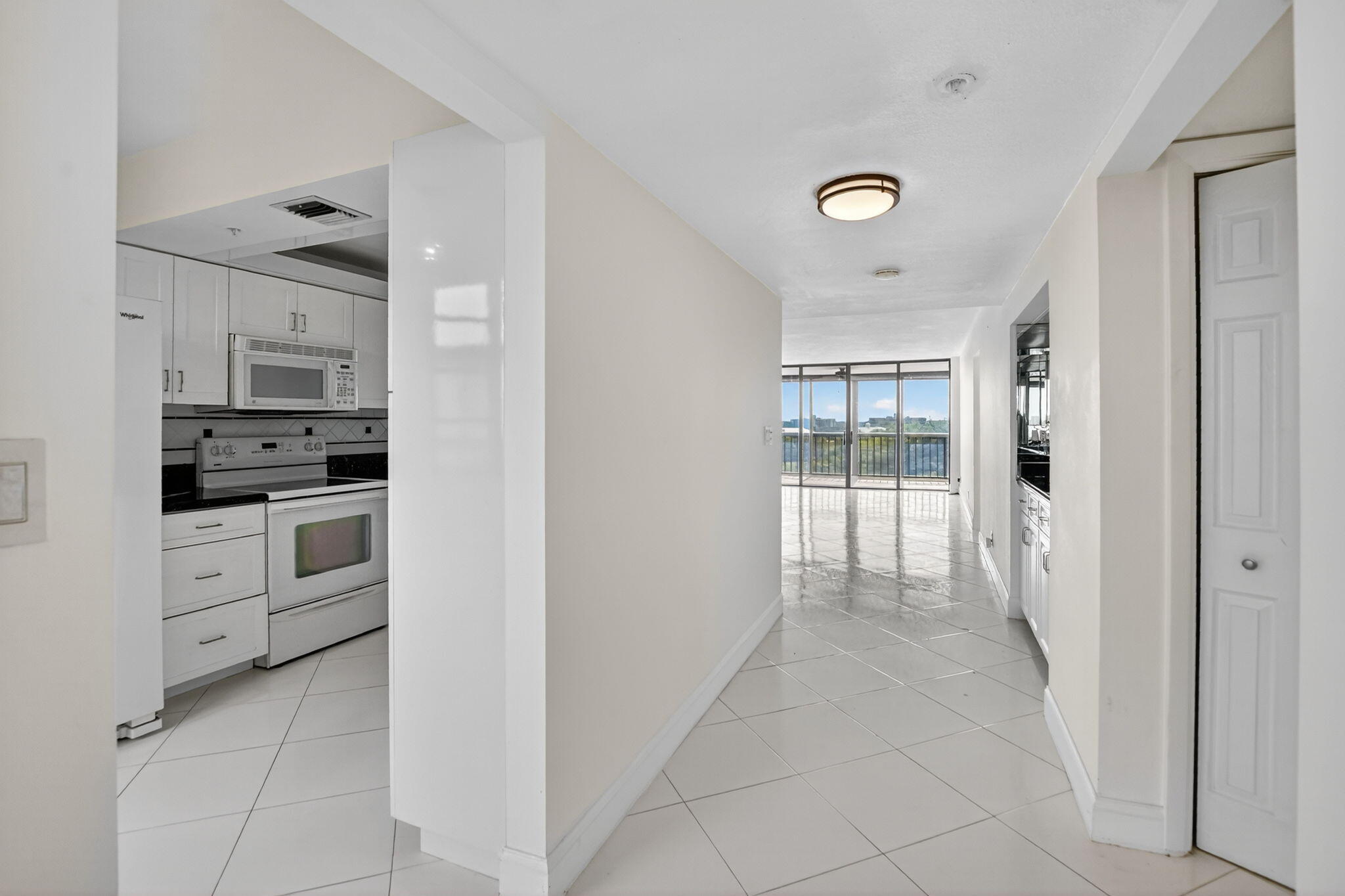 6620 Boca Del Mar Drive, Unit 706 Boca Raton, FL 33433 - Photo 3 of 41 a kitchen with white cabinets and appliances