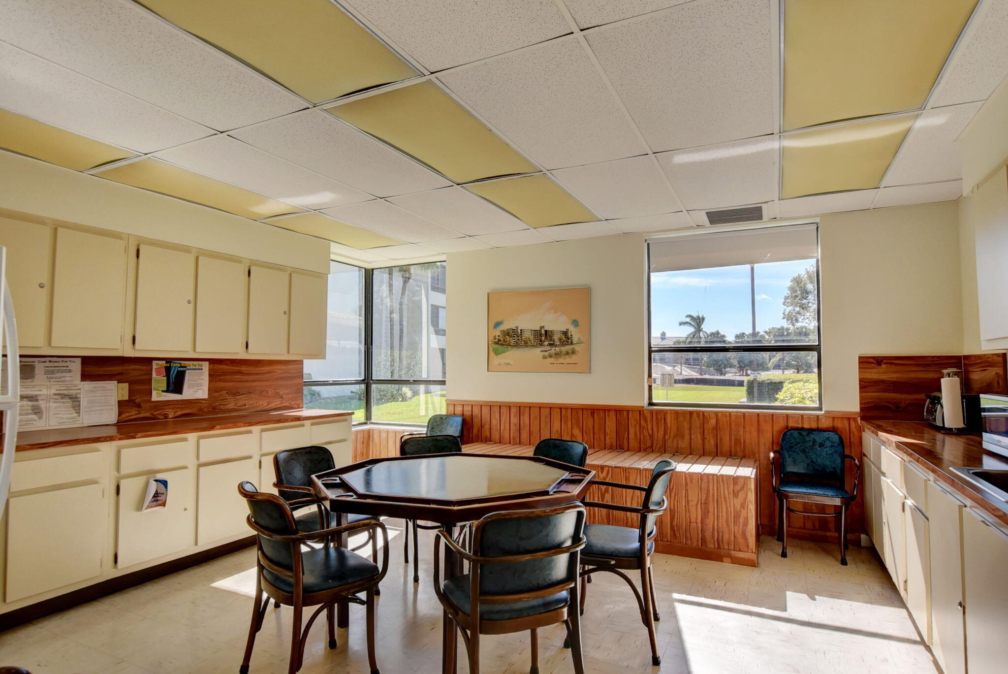 6620 Boca Del Mar Drive, Unit 706 Boca Raton, FL 33433 - Photo 33 of 41 a kitchen with stainless steel appliances a dining table chairs and a refrigerator