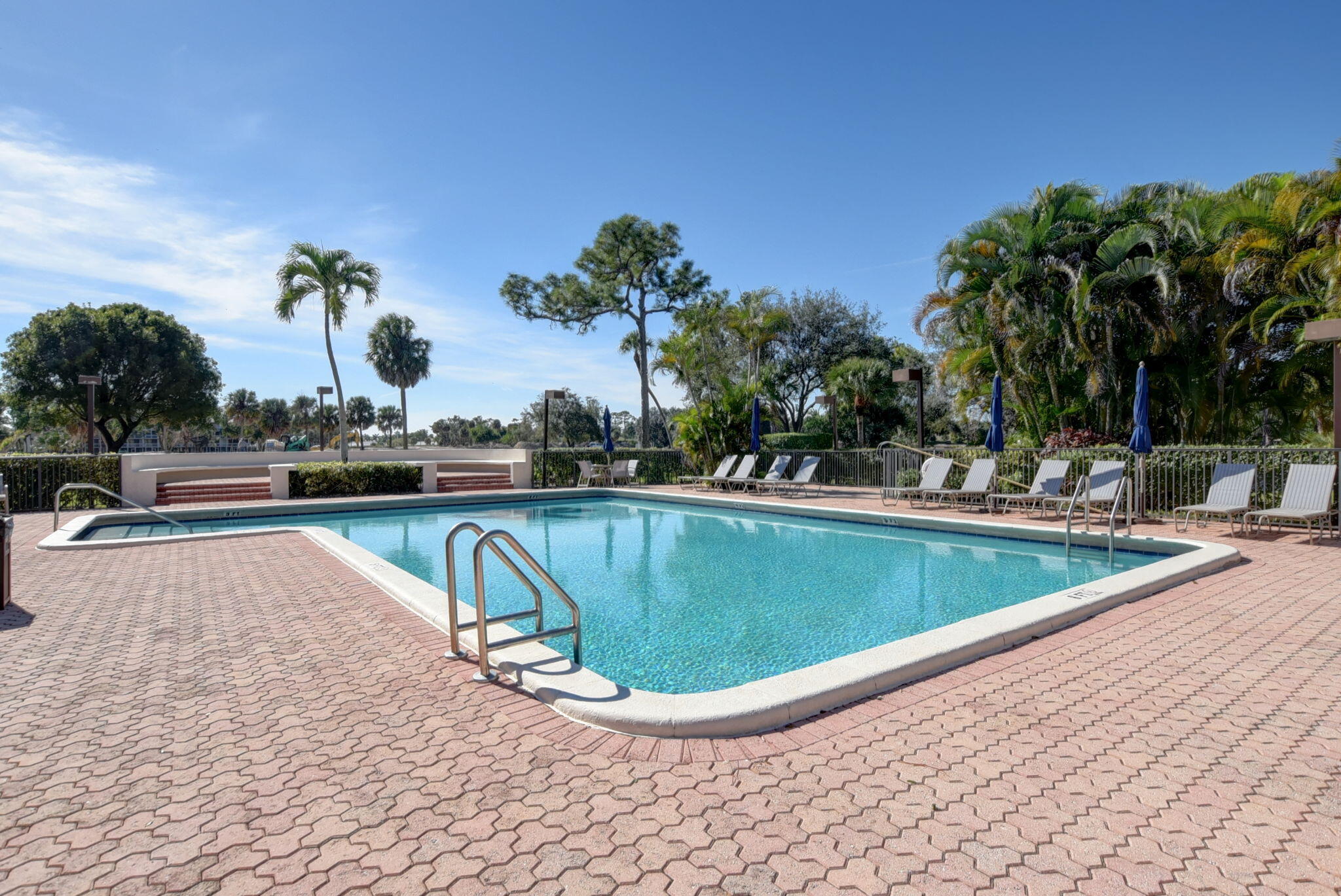 6620 Boca Del Mar Drive, Unit 706 Boca Raton, FL 33433 - Photo 36 of 41 a view of a swimming pool with a lawn chairs and potted plants