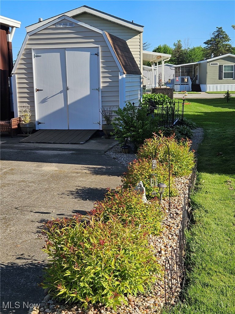 18592 Edwards Road, Unit 132 Doylestown, OH 44230 - Photo 26 of 32 View of shed with plants in bloom