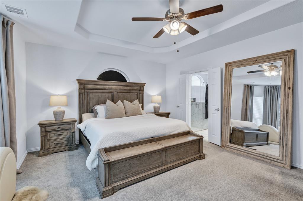 566 Long Meadow Drive Haslet, TX 76052 - Photo 15 of 36 a bedroom with a bed and a chandelier