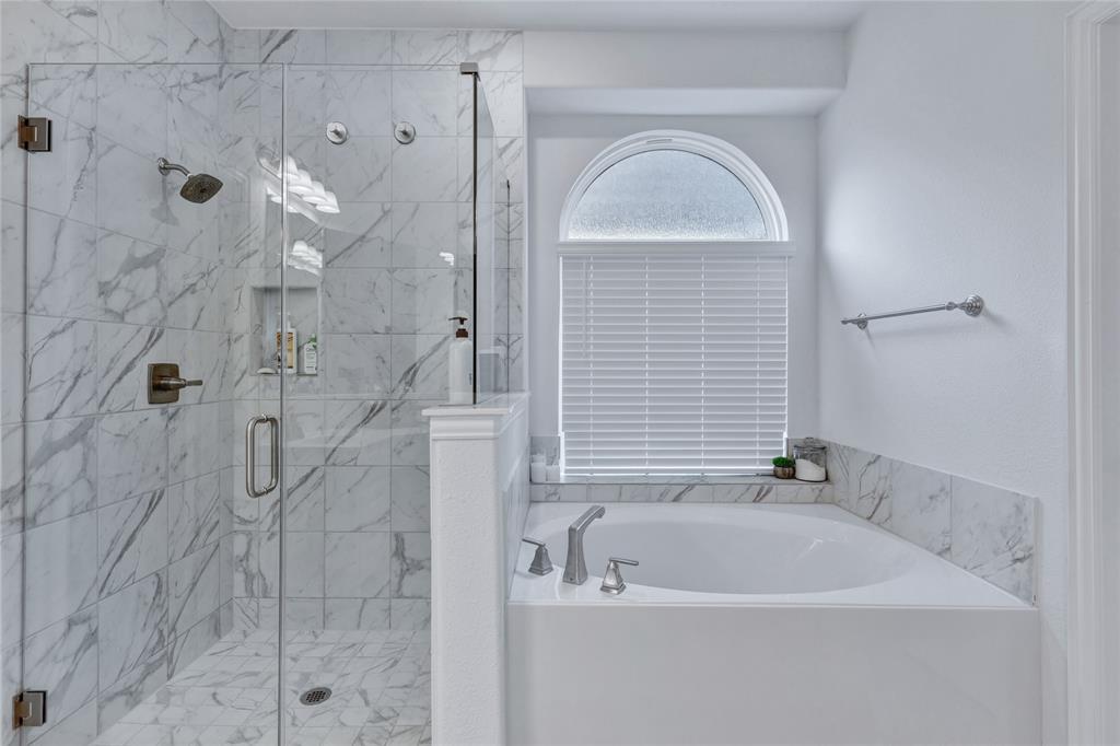 566 Long Meadow Drive Haslet, TX 76052 - Photo 16 of 36 a bathroom with a white bathtub and shower