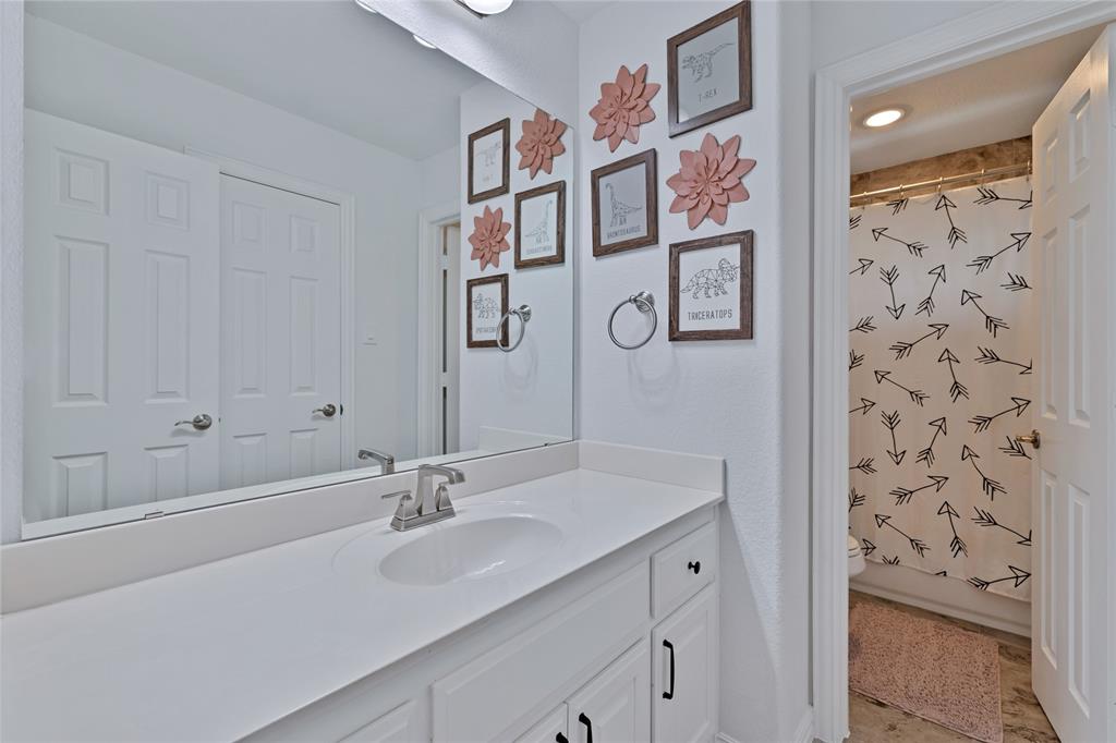 566 Long Meadow Drive Haslet, TX 76052 - Photo 27 of 36 a bathroom with a sink and a mirror