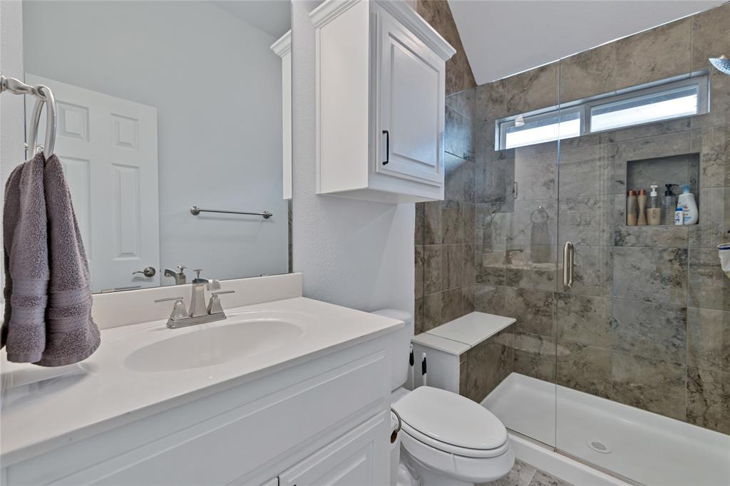 566 Long Meadow Drive Haslet, TX 76052 - Photo 29 of 36 a bathroom with a sink a toilet and shower