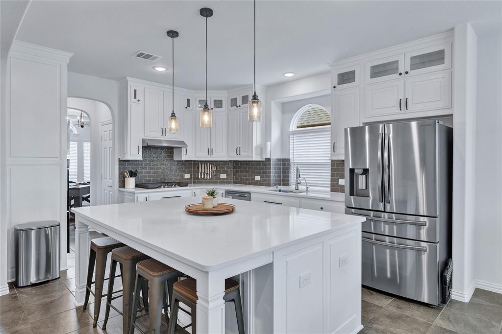 566 Long Meadow Drive Haslet, TX 76052 - Photo 6 of 36 a kitchen with refrigerator a stove and a refrigerator with wooden floor