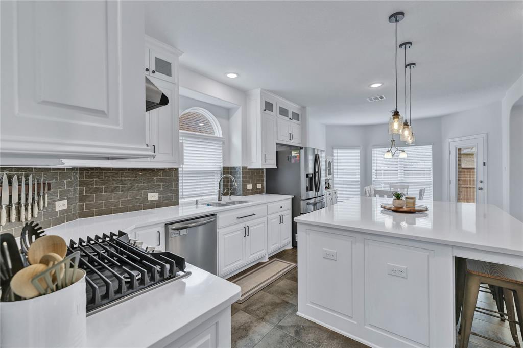 566 Long Meadow Drive Haslet, TX 76052 - Photo 8 of 36 a kitchen with white cabinets and appliances